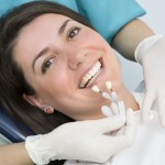 20442854 - a dentist showing porcelain teeth to pacient